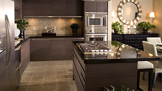 A modern kitchen with new appliances, including a refrigerator, dishwasher, cooktop, and oven