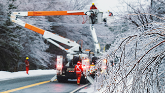 Electrical linemen work to restore power during an intense ice storm.