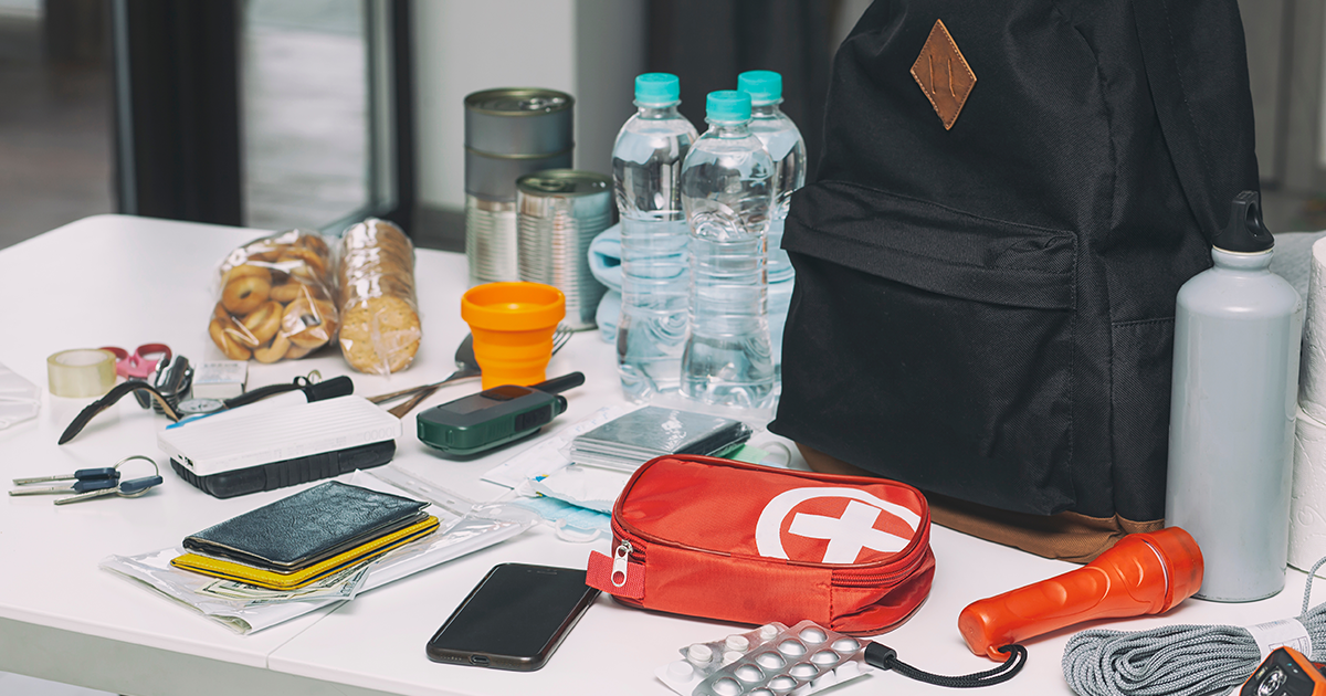 A family works together to plan for a natural disaster or weather emergency with an emergency kit.
