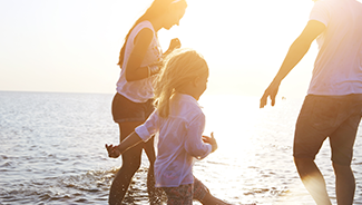 Two adults and a child enjoying summer on the water